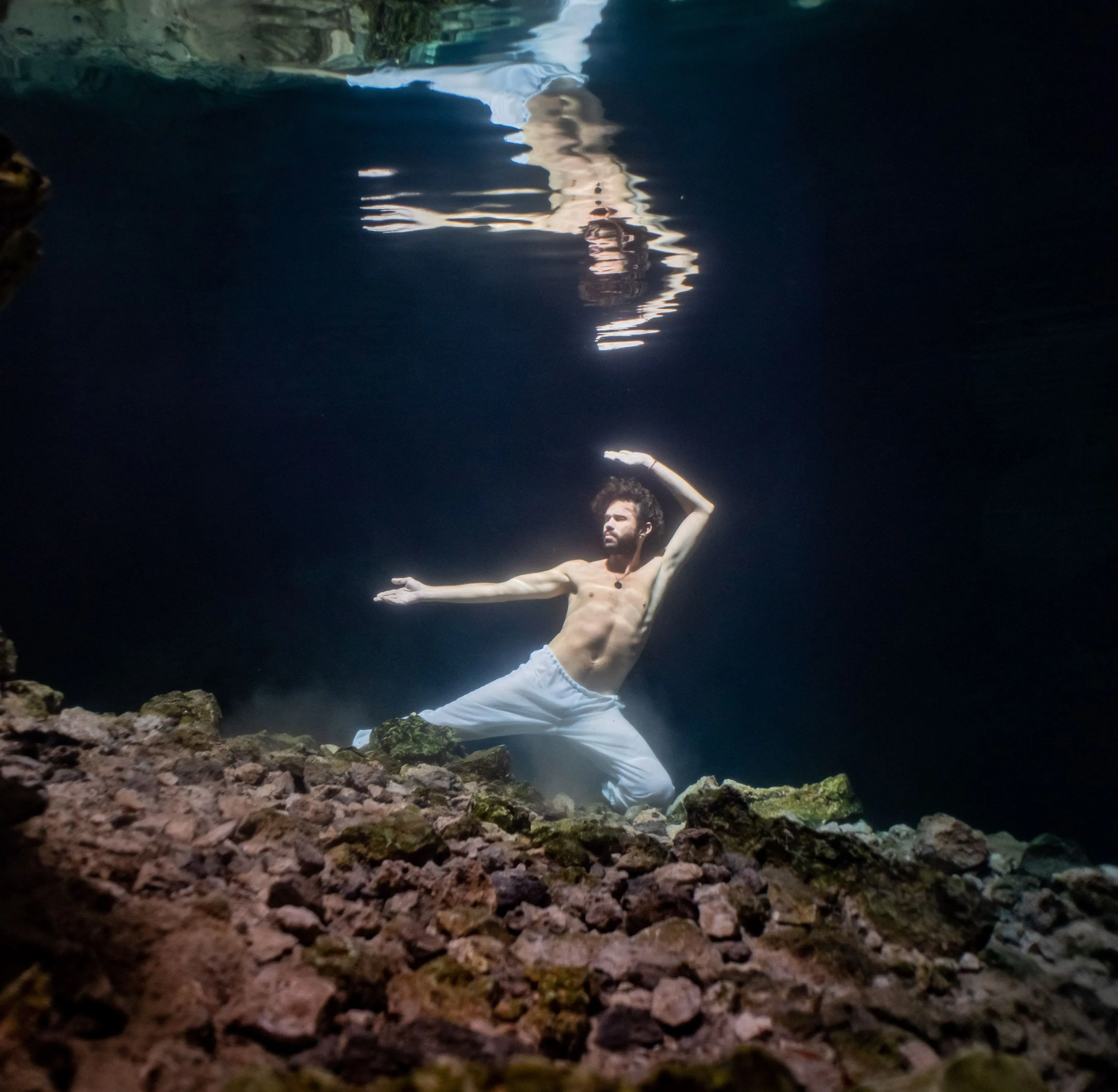 Two figures meeting beneath the surface