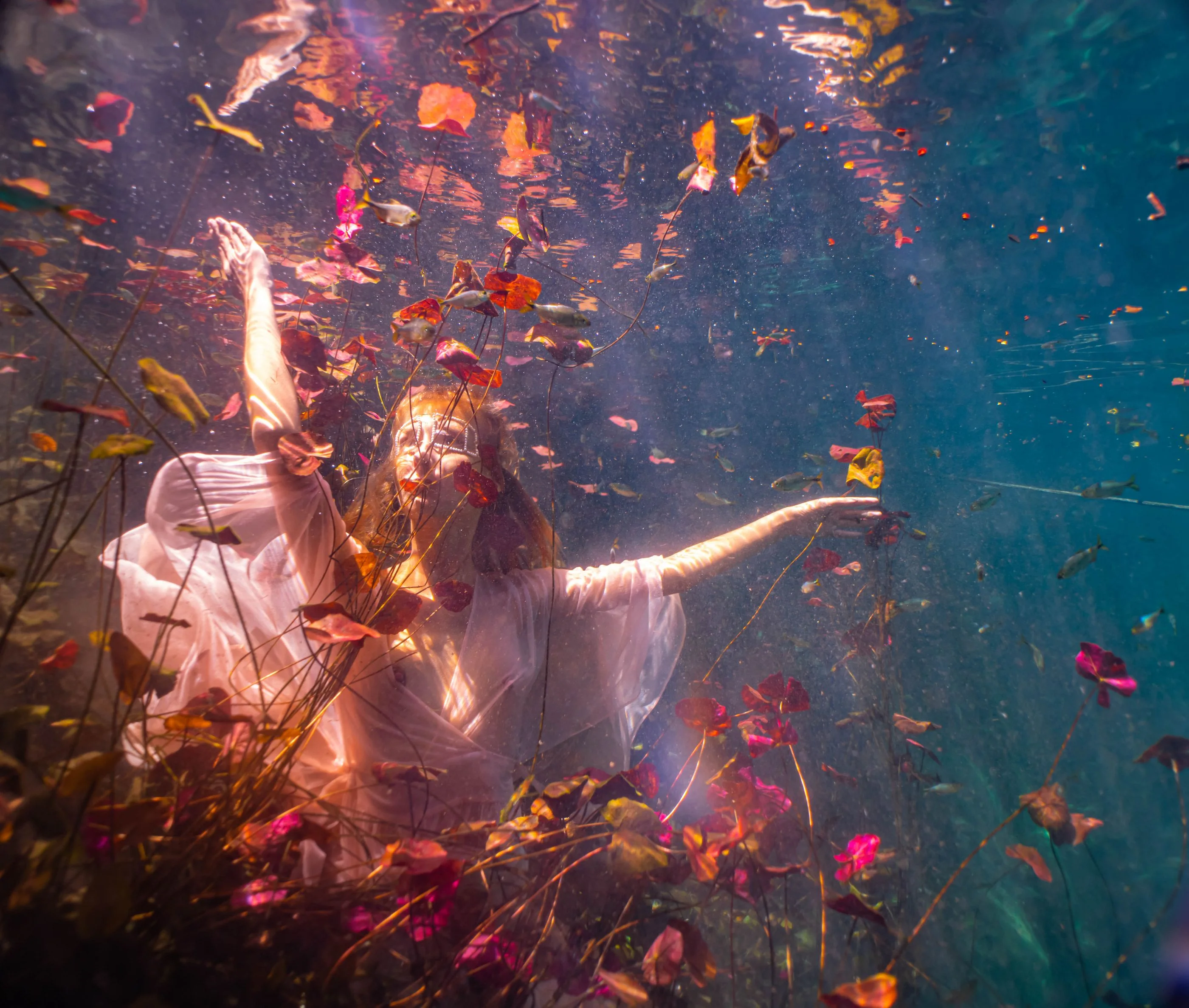 Portrait drifting in still cenote water